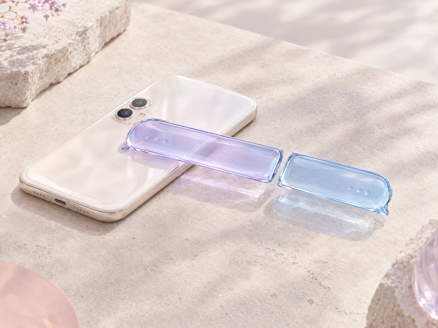 A lavender glass message ribbon divided into two parts beside a pearl smartphone
